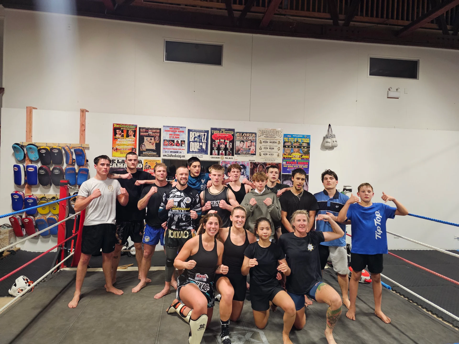 Hurto Gym members posing together inside the boxing ring