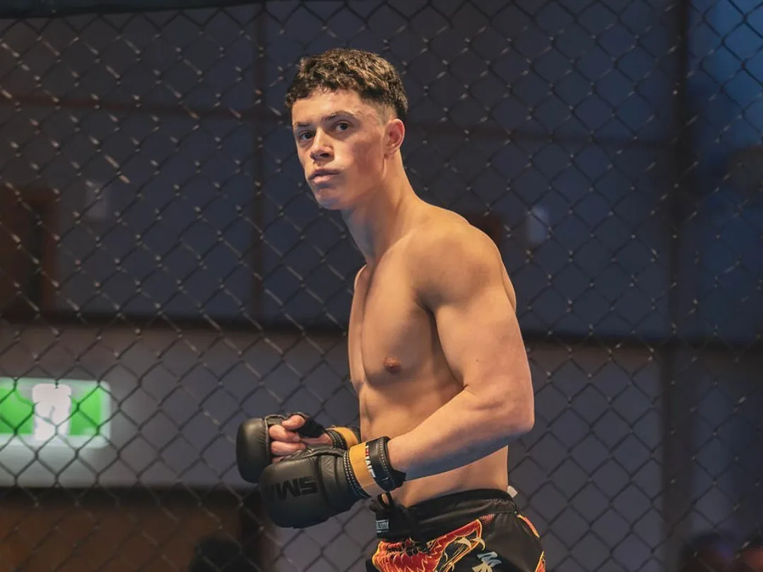 Isaac Mclaughlin standing ready inside the fight cage