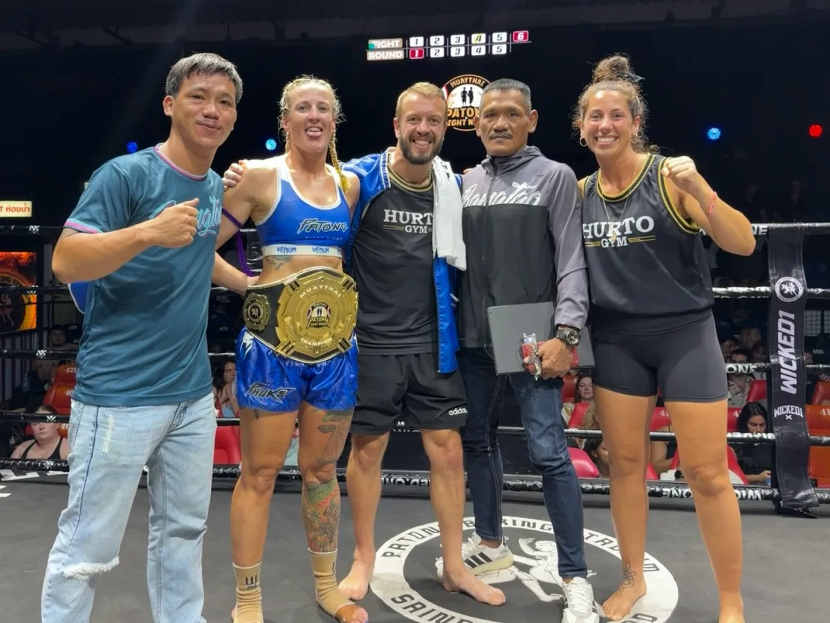 Rishon Harris with the Hurto team celebrating a championship win in the ring